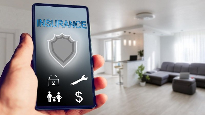 smart home automation insurance - hand held smartphone in smart home