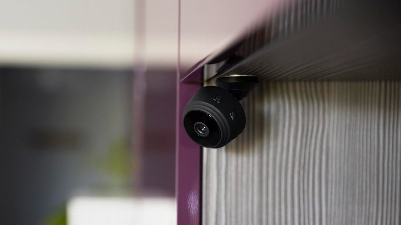 Smart Security Systems for Home Safety - a black security camera attached to a wooden wall