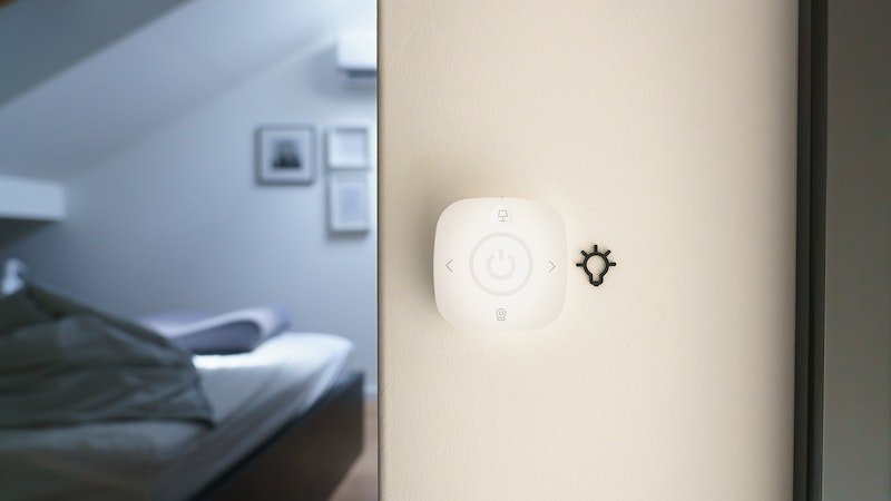 How to Install a Smart Home Automation system in Your Home - a white smart switch on white wall of a bedroom